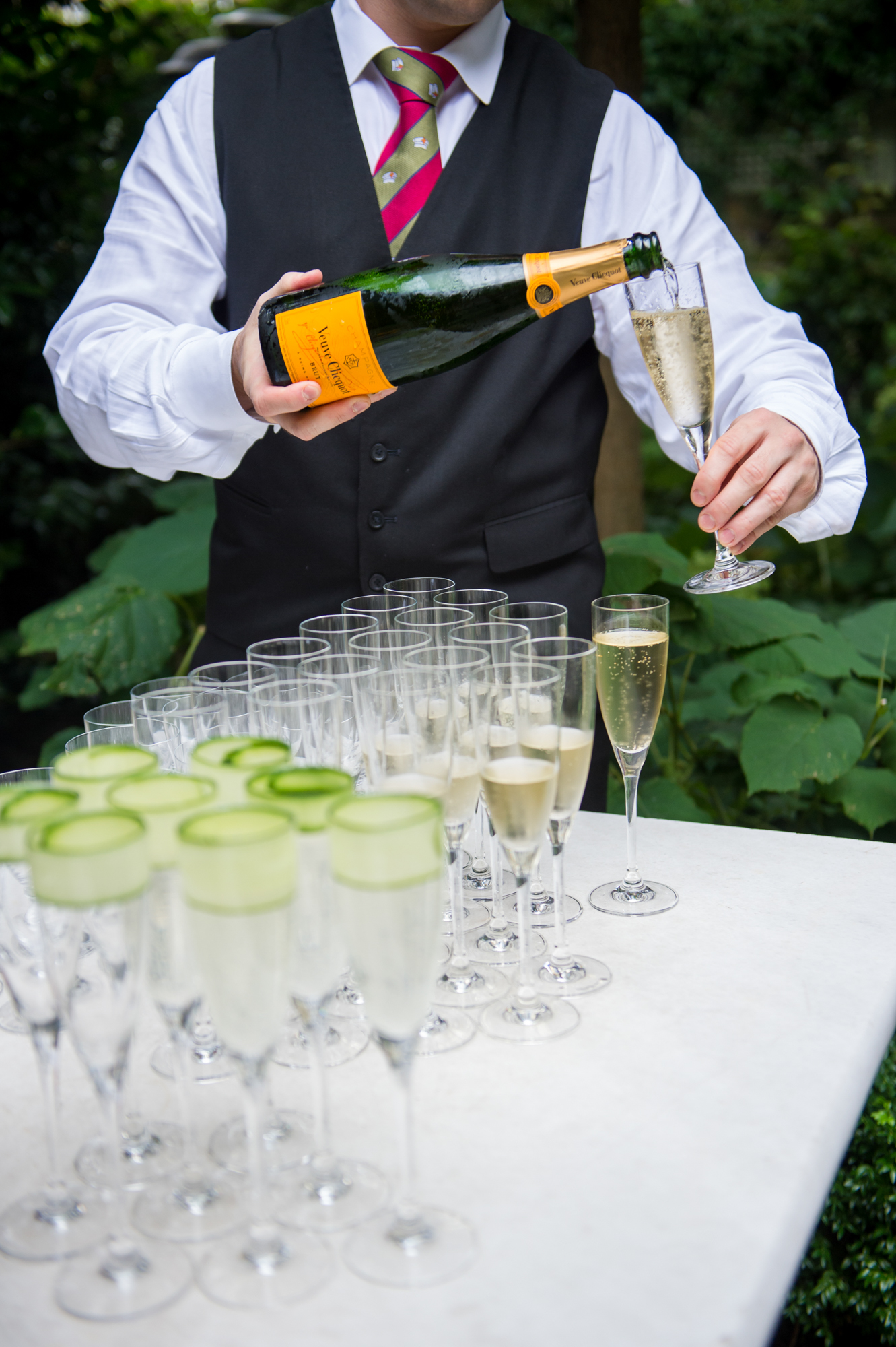 A waiter pouring champagne at a wedding reception